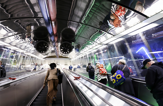 People on a u-tube escalator